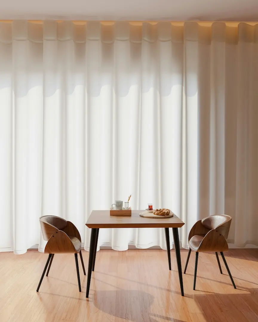 Large open kitchen space in an apartment with black, modern indoor roller blinds cascading down large, sloped windows.